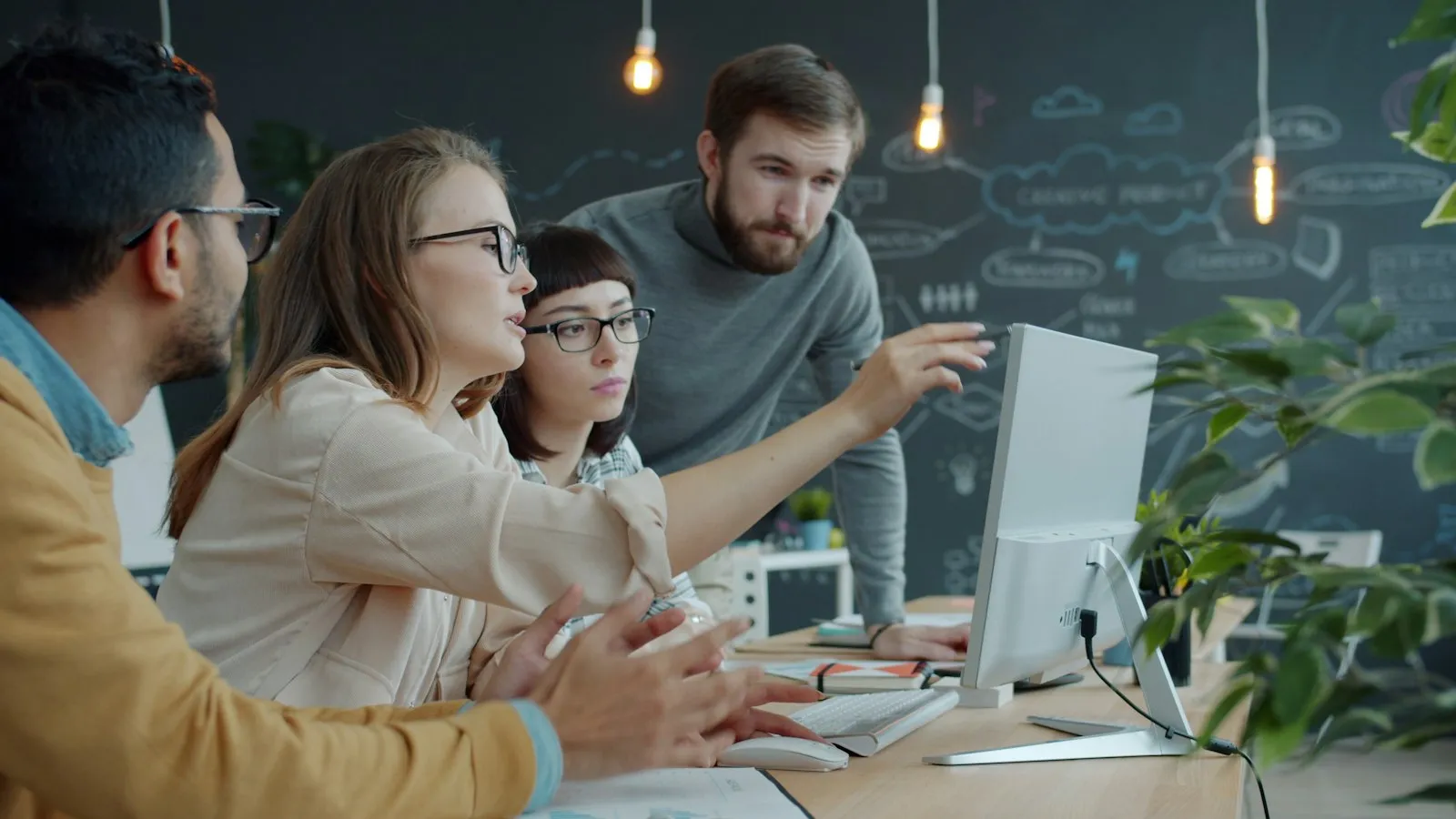 A growth team reviewing results together at a monitor