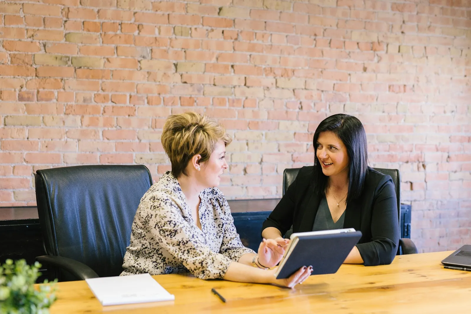 A financial advisor going through a plan with a client on a tablet