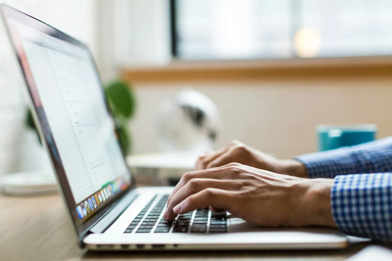A person typing an email on a laptop