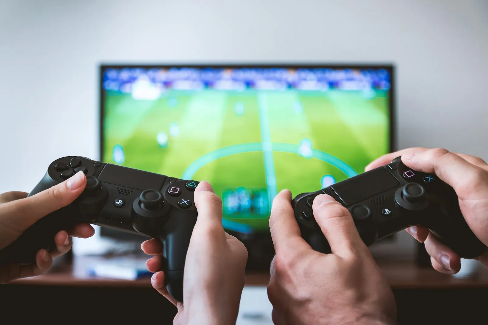 Two people playing a video game with controllers