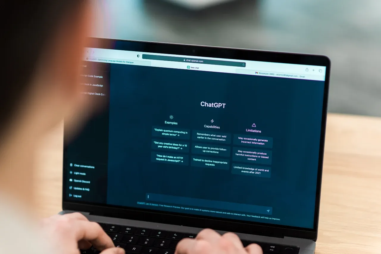 A person using ChatGPT on a laptop