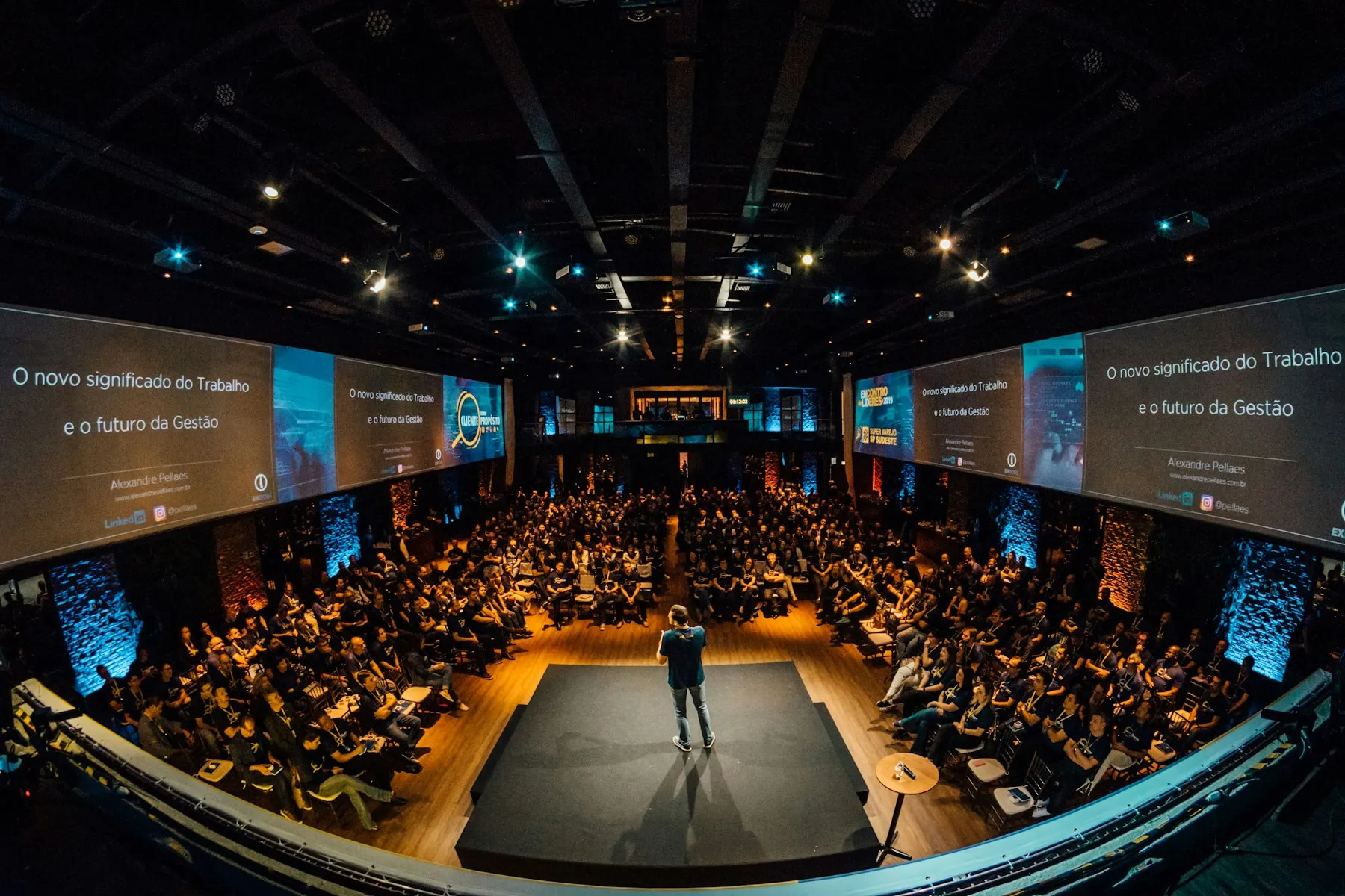 An audience watching a speaker present at a technology conference