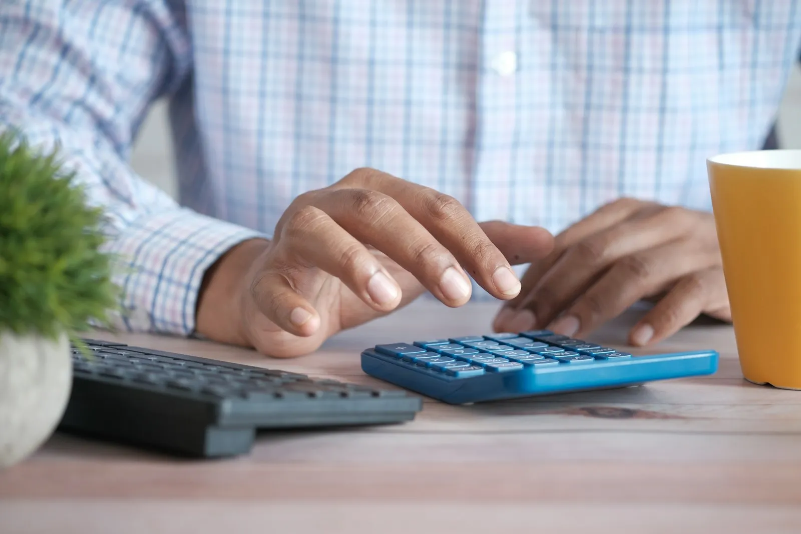 A person working through a budget with a calculator